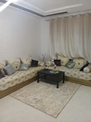 a living room with a couch and a coffee table at Appartement in Fès