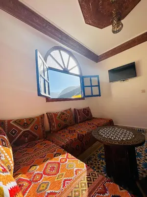 a living room with a couch and a window at Maison Berber in Ourika