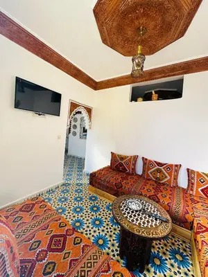 a living room with a couch and a table at Maison Berber in Ourika