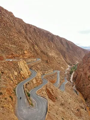 a winding road in the middle of a mountain at bed&breakfast in Merzouga