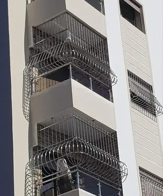 a tall building with a metal cage on the side at Jungle au centre de Marrakech avec Jacuzzi ! Partager EnregistrerJungle au centre de Marrakech avec Jacuzzi ! Partager Enregistrer in Fès