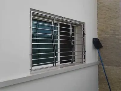 a window with a metal grate on the side of a building at Jungle au centre de Marrakech avec Jacuzzi ! Partager EnregistrerJungle au centre de Marrakech avec Jacuzzi ! Partager Enregistrer in Fès