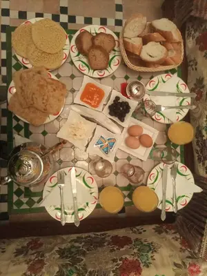 a table with plates of food on a table at Dar Fes Familly in Fès