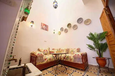 a living room with a couch and a table at Dar Fes Familly in Fès