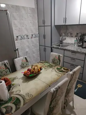 a kitchen table with a bowl of fruit on it at Dar Fes Familly in Fès