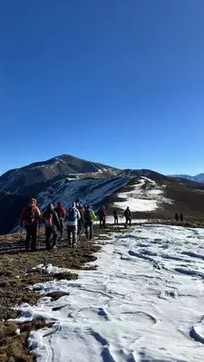 a group of people walking up a snow covered hill at Dar Ayoub in Inlghdene