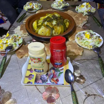a table with plates of food and a bowl of food at Dar Ayoub in Inlghdene