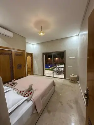 a bedroom with a large bed and a large window at Villa Bellevue in Sbiti