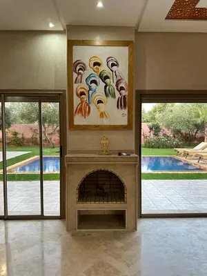 a living room with a fireplace and a painting on the wall at Villa Bellevue in Sbiti