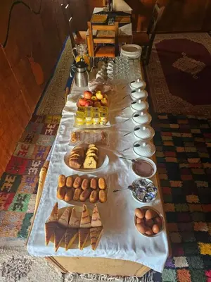 a long table filled with different types of food at Magnifique Luxury Camp in Merzouga
