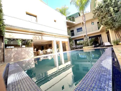 a swimming pool in front of a house at Maison d 'Hôtes de Charme 7 Ch in Sidi Bouzguia