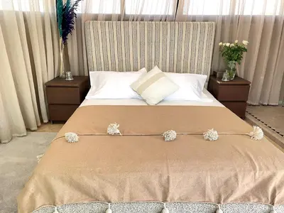 a bedroom with a large bed with flowers on it at Maison d 'Hôtes de Charme 7 Ch in Sidi Bouzguia
