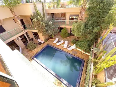 an overhead view of a swimming pool in a building at Maison d 'Hôtes de Charme 7 Ch in Sidi Bouzguia
