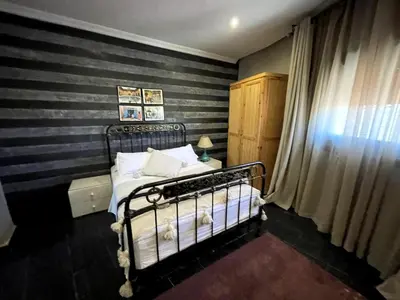 a bedroom with a black and white striped wall at Maison d 'Hôtes de Charme 7 Ch in Sidi Bouzguia