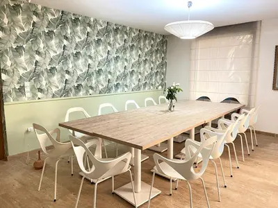 a conference room with a wooden table and chairs at Maison d 'Hôtes de Charme 7 Ch in Sidi Bouzguia