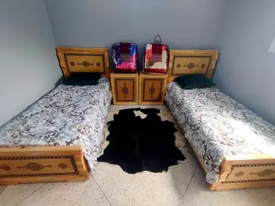 two beds sitting next to each other in a room at Gite touristique bouknala in Abinane