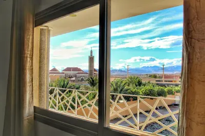a window view of the desert from a hotel room at Palmiers Hôtel Club in Er Rachidia
