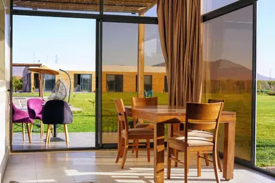 a dining room with a table and chairs at Getaway between nature and adventure in Marrakech