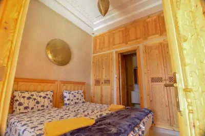 a bedroom with a bed with yellow towels on it at Jnane az Zatr Villa and pool Ourika in Ourika