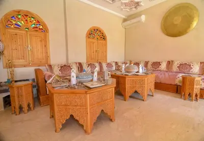 a living room with two tables and a couch at Jnane az Zatr Villa and pool Ourika in Ourika