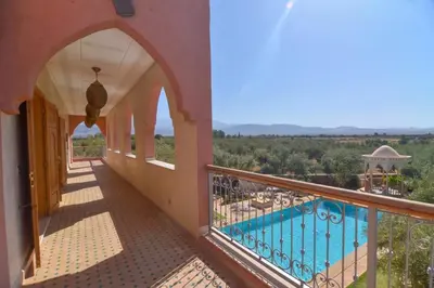 a balcony of a house with a swimming pool at Jnane az Zatr Villa and pool Ourika in Ourika