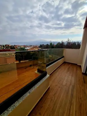 a balcony with a view of a wooden floor at Lusail in Beni Mellal
