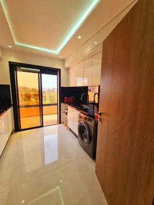 a kitchen with a washing machine in a room at Lusail in Beni Mellal