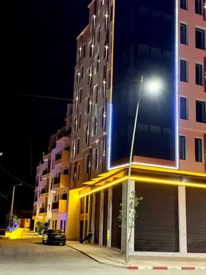 a street light in front of a building at night at Lusail in Beni Mellal