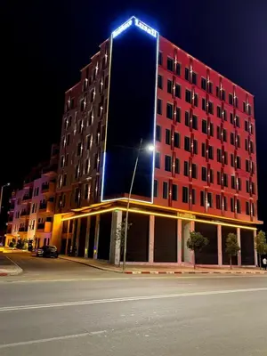 a red building with a light on top of it at Lusail in Beni Mellal