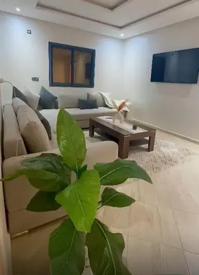 a living room with a couch and a table at Appartement de luxe à khouribga in Khouribga