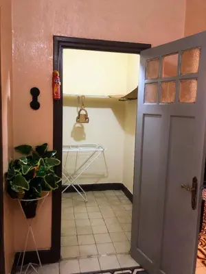 a door leading into a kitchen with a plant at Tisra Appartement in Meknès