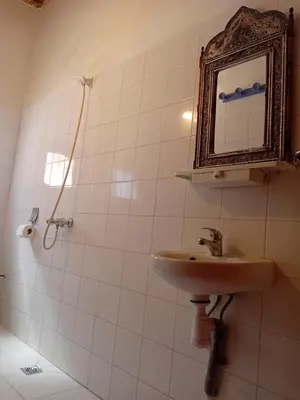 a bathroom with a sink and a mirror at Hotel Source De Dades in Boumalne