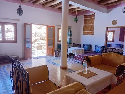 a living room with couches and a table at Hotel Source De Dades in Boumalne