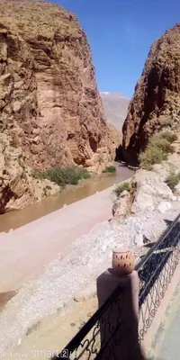 a bridge over a river in a canyon at Hotel Source De Dades in Boumalne
