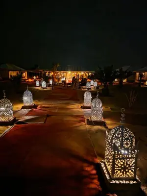 a row of lights in a park at night at Amrad luxury camp in Merzouga