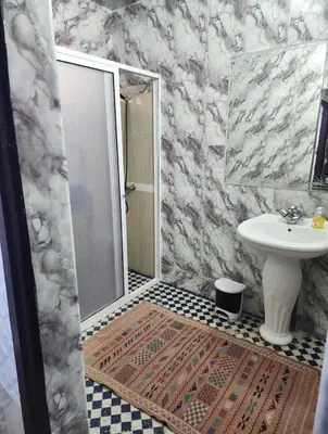 a bathroom with a shower and a sink and a toilet at Dar Zerbtana suite Kenza in Fès