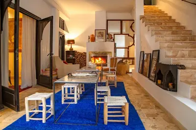 a living room with a table and chairs and a fireplace at Charming 5 bedroom in Marrakech