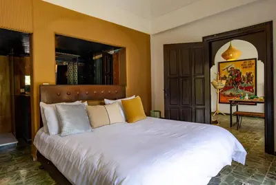 a bedroom with a large bed with white sheets at Charming 5 bedroom in Marrakech