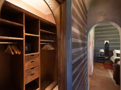 a wine cellar with wooden shelves and an archway at Villa Layyine avec personnel, piscine, spa et sports in Marrakech