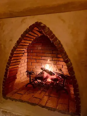 a brick oven with a fire in it at Villa Dar Al Hayat in Marrakech