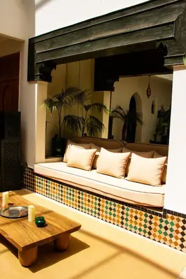 a couch sitting in a room with a table at Villa Dar Al Hayat in Marrakech