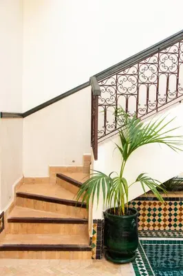 a plant in a pot next to a staircase at Villa Dar Al Hayat in Marrakech