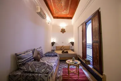 a living room with a couch and a table and a window at Dar Bab jdid fez in Fès