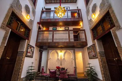 a hallway of a house with a table and a chandelier at Dar Bab jdid fez in Fès