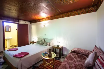 a bedroom with a bed and a couch at Dar Bab jdid fez in Fès
