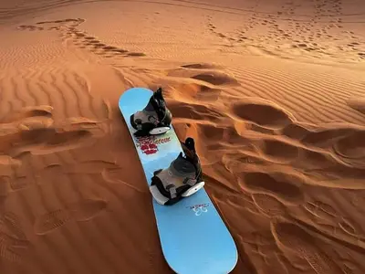 a snowboard in the sand in the desert at Soul Dunes Luxury Camp in Merzouga