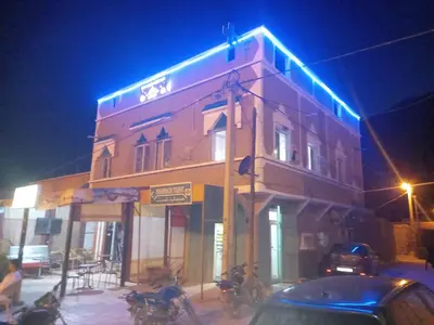 a building with blue lights on the side of it at Hôtel et restaurant Dyafa in Tissint
