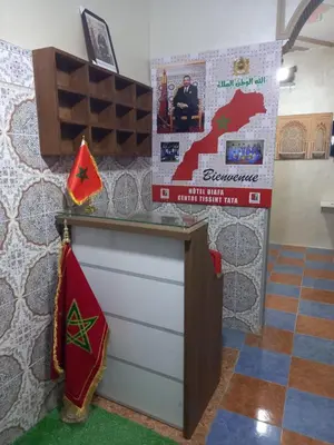a room with a counter and a map on the wall at Hôtel et restaurant Dyafa in Tissint