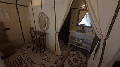 a small bathroom with a sink and a mirror at Merzouga Safari Luxury Camp in Tisserdmine