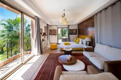 a living room with a bed and a couch at Villa Lumina in Marrakech
